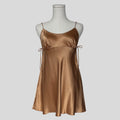 Silk slip dress with side cutouts and bows in gold