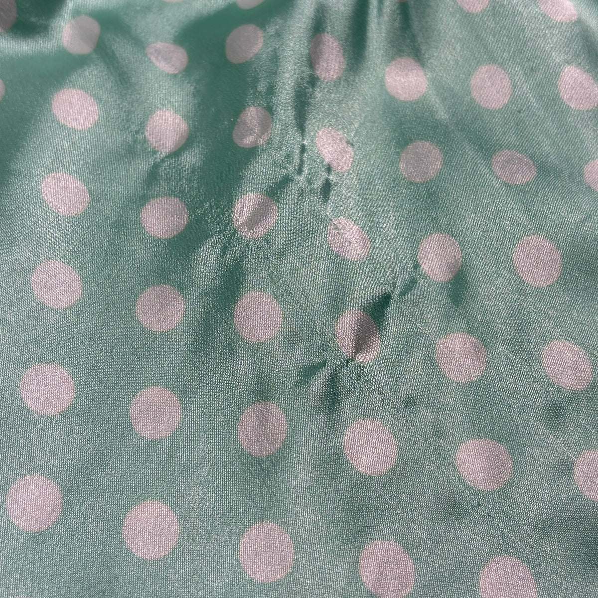Silky polka dot ruffled slip in teal and white